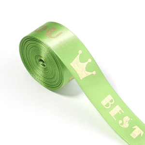 Detail of light green satin ribbon with gold crown print and Best You lettering for gifts