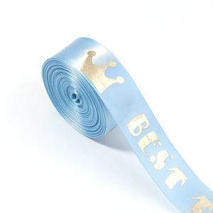 Detail of light blue satin ribbon with gold foil crown and BEST lettering on white background