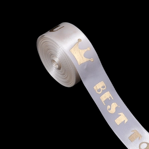 Detailed view of white satin ribbon with gold crown and Best To print for gift wrapping