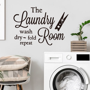 Black 'The Laundry Room' wall decal with wash dry fold repeat text on white wall