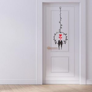 Close-up of minimalist black bird and vine wall stickers on a white interior wooden door