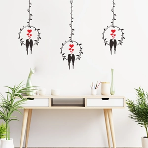 Minimalist wall decals with black birds, vine rings, and red hearts in modern home interior