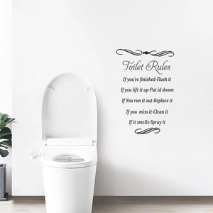 Detail of Toilet Rules wall sticker with artistic lettering in a modern bathroom setting