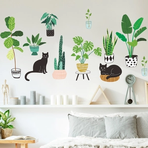Vue détaillée de stickers muraux illustrant des plantes tropicales et chats noirs en chambre