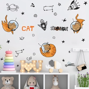 Detailed close-up of cartoon astronaut cat wall stickers in a cozy nursery room setting
