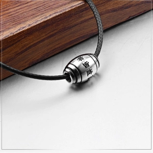 Ethnic titanium steel cylinder pendant with engraved Nine Word Mantra on braided cord