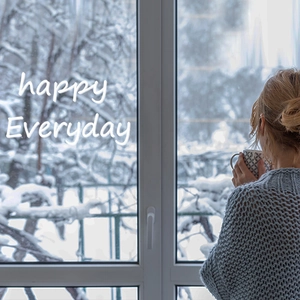 Cosy grey-blue chunky knit sweater for women in a serene winter home setting