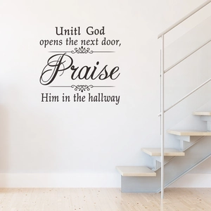 Black vinyl Praise religious wall decal with inspirational quote on a white staircase wall
