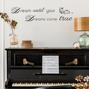 Inspirational Dreams Come True wall decal with floral art above a black piano