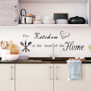 Detail of black PVC kitchen wall sticker with heart and cutlery graphics on white cabinets