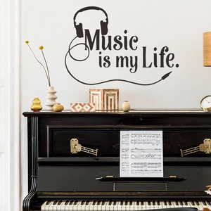 Detail showing Music is my Life wall sticker with headphones above a piano in a music room