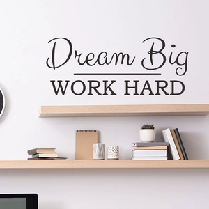 Detail of Dream Big Work Hard wall sticker on white wall above a minimalist desk