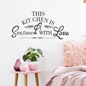 Detail of 'this kitchen is seasoned with love' wall decal with leaf accents