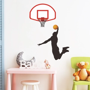 Detail view of basketball slam dunk wall decal set on bedroom wall with furniture
