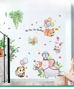 Nursery wall decals featuring cartoon animals and green plants in a cozy room setting
