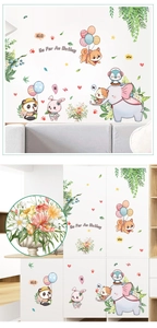 Detail showing cartoon elephant and panda stickers on a white cabinet with macro view