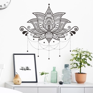 Detail of black mandala lotus wall sticker with intricate patterns on a white living room wall