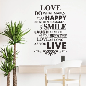 Macro detail of LOVE wall sticker with inspiring quotes on a clean white interior wall