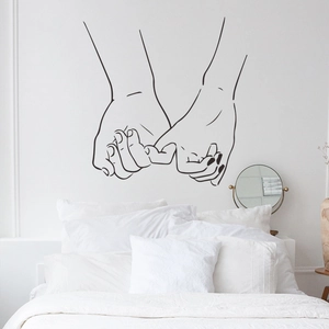 Minimalist hand-holding line art wall decal above a white bed in a modern bedroom décor
