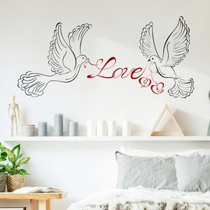 Wall decal detail showing two black doves and red Love text in a modern bedroom setting