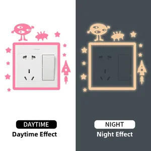 Glow-in-the-dark rocket alien switch sticker daytime vs night luminous effect display
