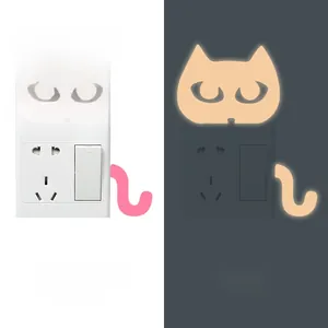 Glow-in-the-dark cat wall sticker showing both daytime pink and nighttime orange luminous effect
