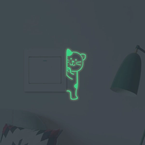 Luminous peeping cat wall sticker glowing green on a light switch in the dark room