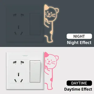 Luminous peeping cat wall sticker showing bright yellow glow in dark and pink color in daylight
