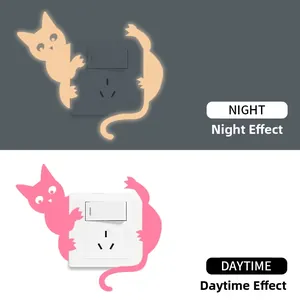 Luminous cat wall sticker showing glow-in-the-dark orange and pink daytime effects