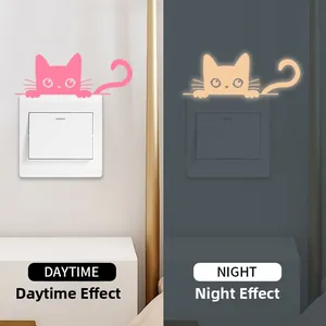 Glow-in-the-dark cat light switch sticker showing day and night fluorescence contrast