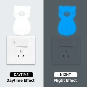 Luminous cat light switch sticker showing daytime white and nighttime blue glow effect