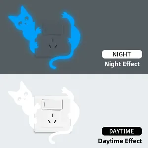Glow in the dark cat wall sticker showing daytime white and night blue light effects