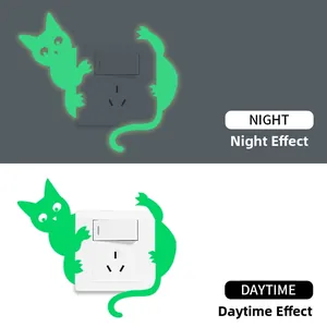 Glow-in-the-dark cat switch wall sticker showing day and night luminous contrast effect