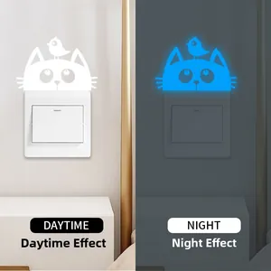 Glow-in-the-dark cat and bird switch wall stickers showing daytime and nighttime effects