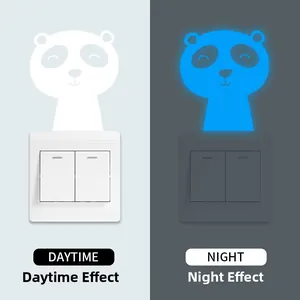 Luminous panda light switch sticker with blue glow effect for dark wall decoration