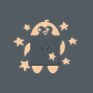 Luminous penguin and stars wall sticker surrounding a dark gray five-hole power outlet
