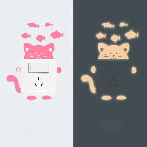 Luminous cat and fish wall sticker showing daytime appearance and nighttime glow effect