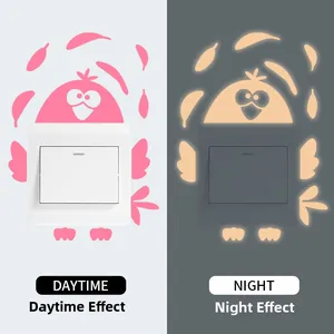 Luminous cartoon bird switch sticker showing daytime view and glowing night effect