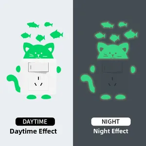 Glow-in-the-dark cat and fish light switch stickers showing day and night contrast
