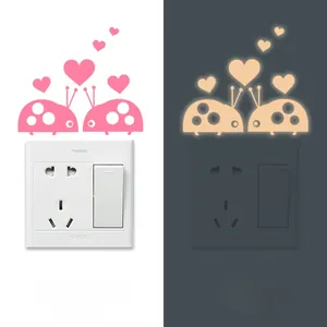 Luminous ladybug wall sticker showing pink daytime color and orange glow at night