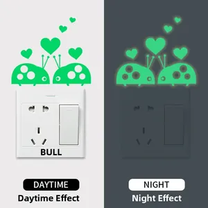 Glow-in-the-dark ladybug heart wall stickers for switches shown in day and night modes