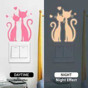 Luminous wall sticker showing daytime pink cat vs nighttime glowing yellow effect