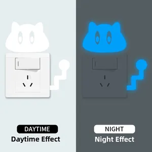 Glow-in-the-dark cat light switch sticker showing daytime white and night blue fluorescent effect
