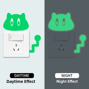 Glow-in-the-dark cat wall sticker shown in day and night lighting contrast detail