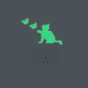 Luminous wall stickers featuring a cat and butterflies glowing green in the dark
