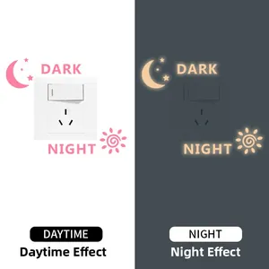 Luminous wall sticker showing day and night effects of moon and stars around switch