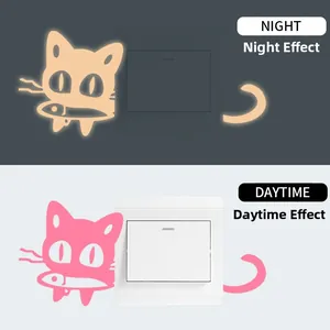 Glow-in-the-dark cat wall sticker showing daytime pink and nighttime orange fluorescent effects