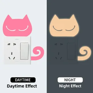 Luminous cat wall sticker showing pink daytime look and green night glow effect