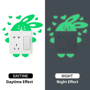 Glow-in-the-dark cartoon rabbit heart light switch sticker shown in day and night contrast