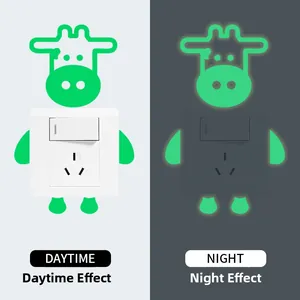 Luminous cow light switch sticker showing daytime and night glow effects side by side